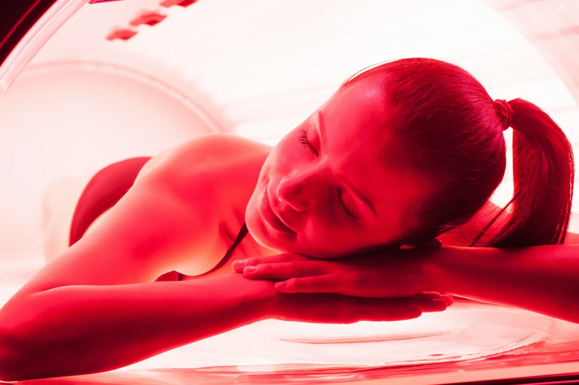 Woman Enjoying Red Light Therapy Session: Enhancing Relaxation and Healing with Near Infrared Light